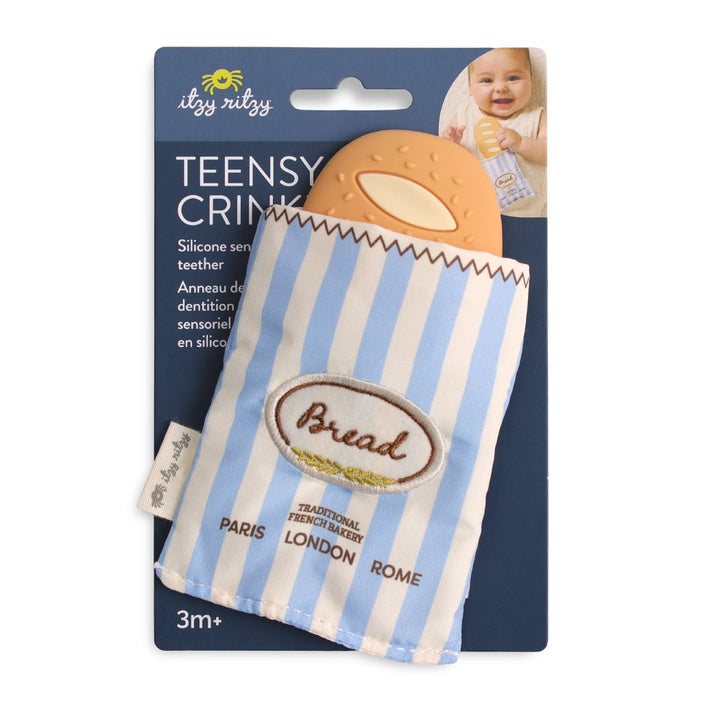 Silicone baguette-shaped baby teether in blue striped fabric pouch with bread motif, packaged