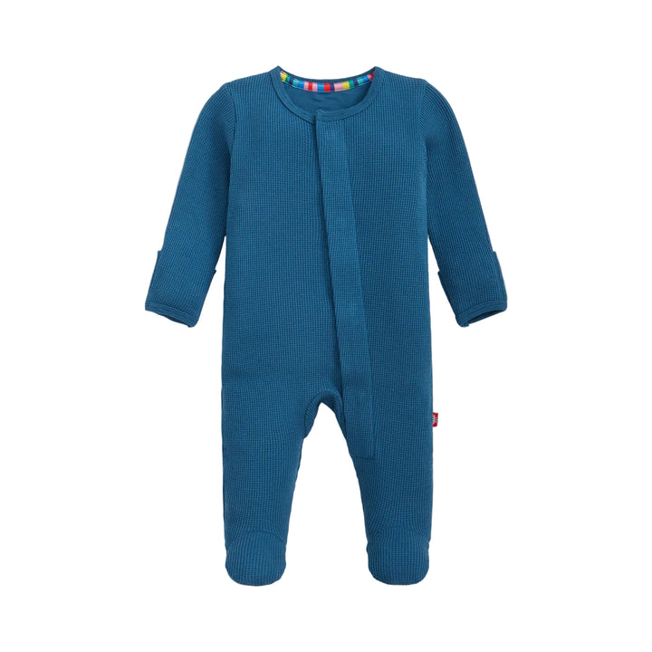 Dark blue waffle knit baby footie pajamas with long sleeves, laid flat on white background