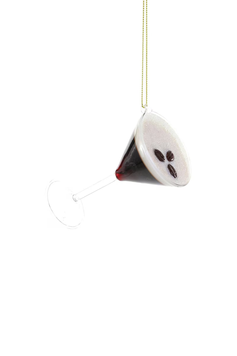 Decorative martini glass ornament with a ghost face on a white background