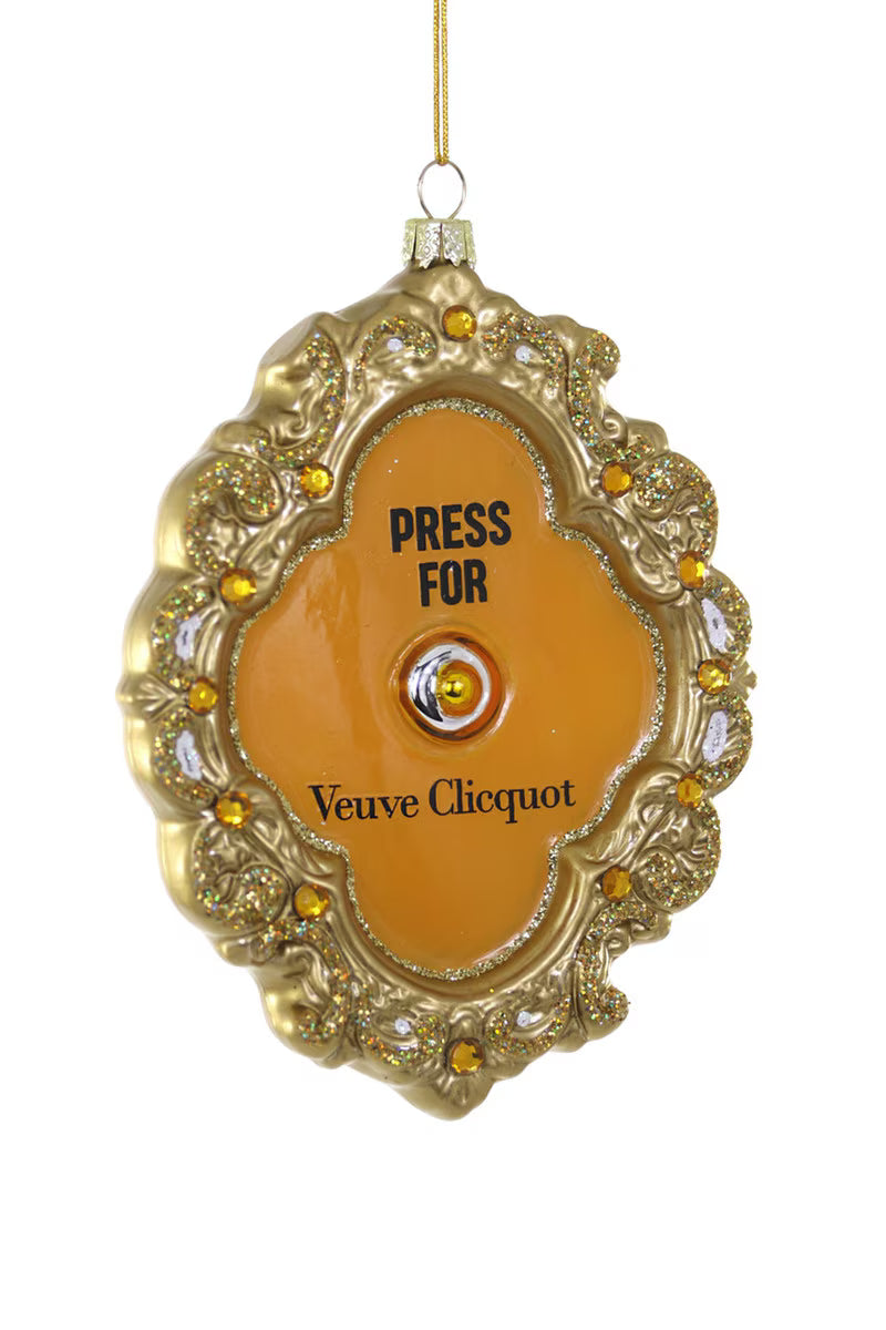 Decorative Veuve Clicquot bell with gold embellishments on a white background