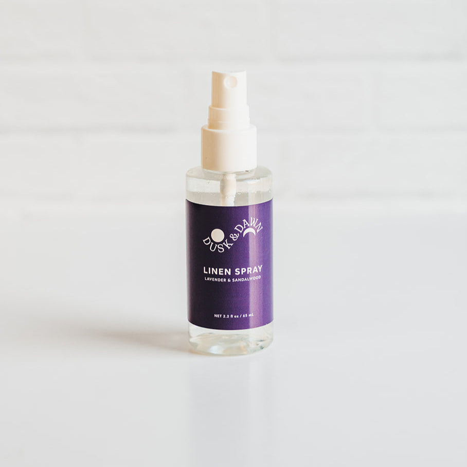 Linen spray bottle with a purple label on a white background