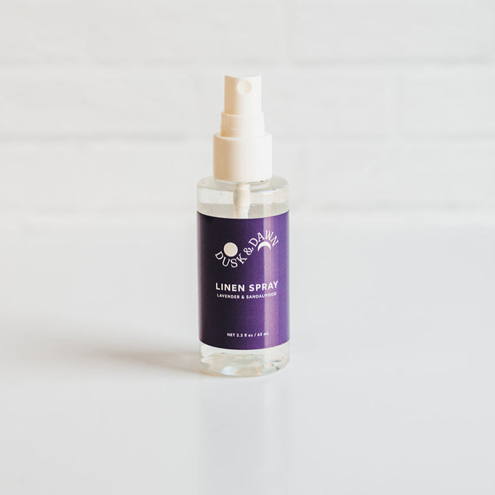 Linen spray bottle with a purple label on a white background