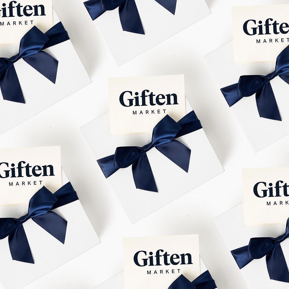 Multiple white gift boxes with a satin bow on top, each bearing the 'Giften Market' brand label.