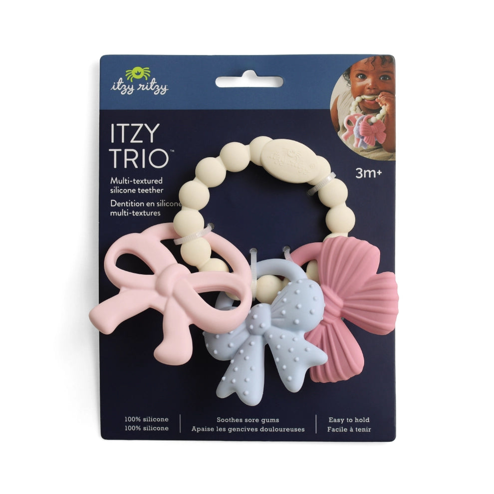 Multi-textured silicone teething toy with pastel bow shapes on retail display card
