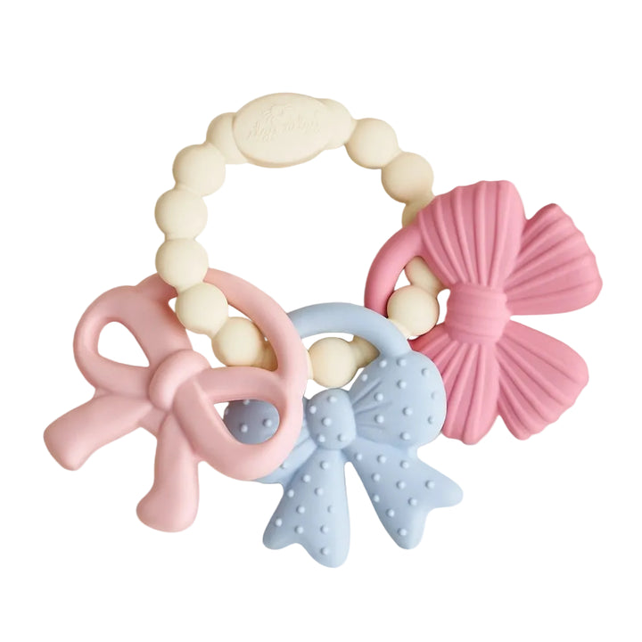 Silicone baby teething ring with pastel pink and blue bow-shaped charms