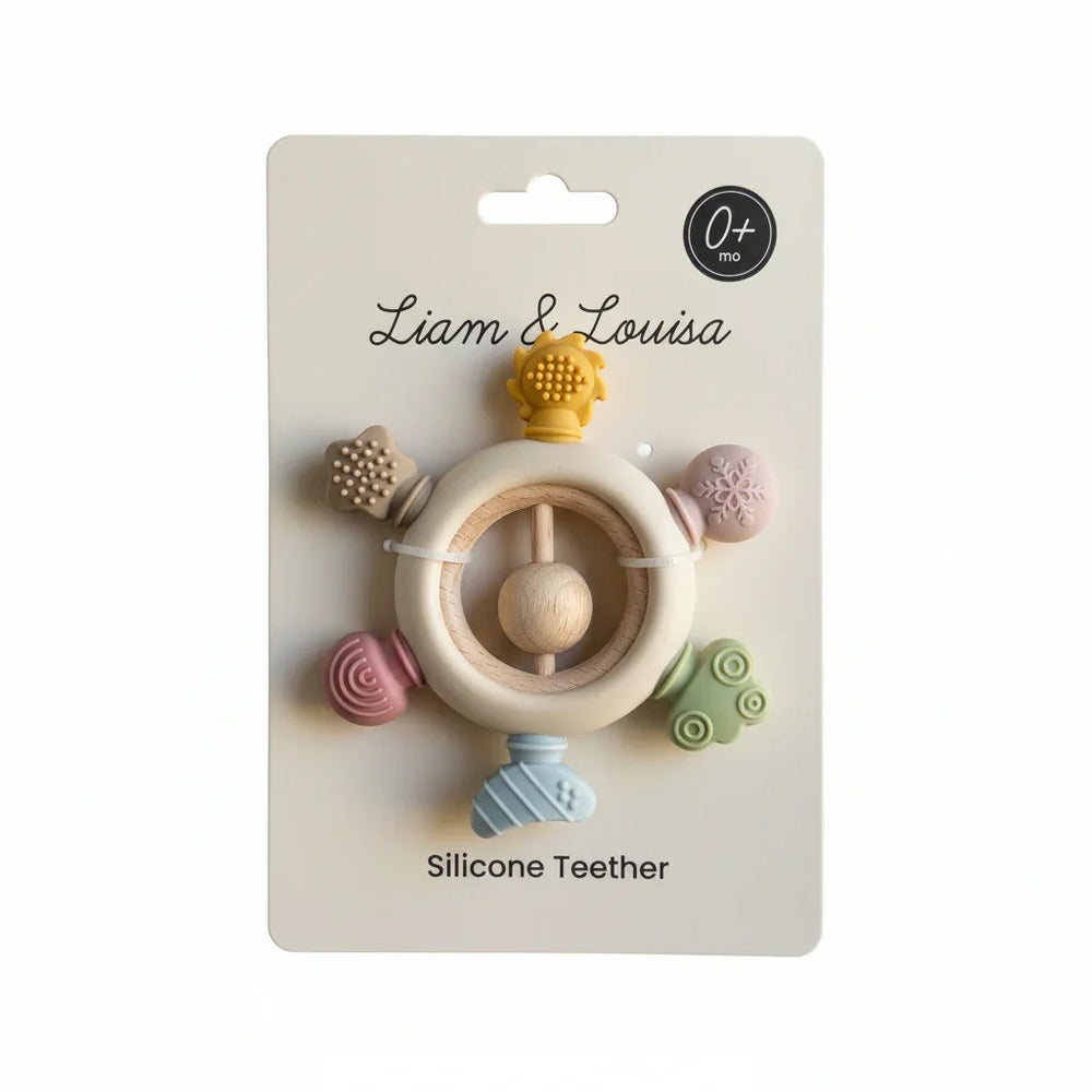Silicone teether with colorful designs on a Liam & Louisa packaging
