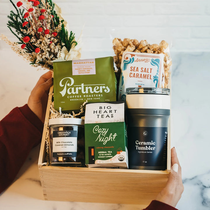 Luxury Coffee Break Crate with coffee, tea, popcorn, chocolate almonds, tumbler, and holly bouquet.
