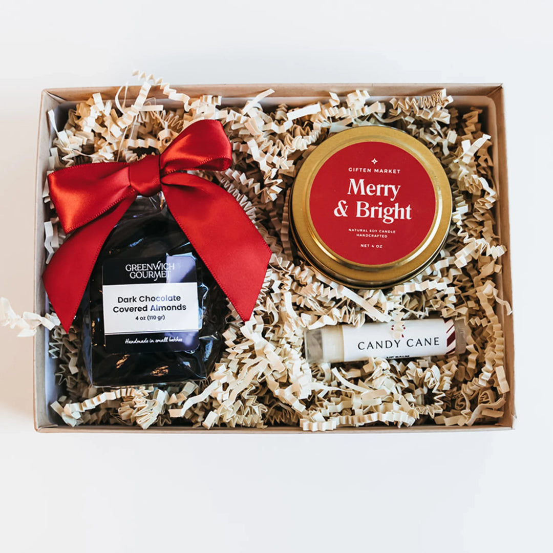 Merry & Bright Mini Bento Box with gold candle, candy cane lip balm, and dark chocolate-covered almonds.