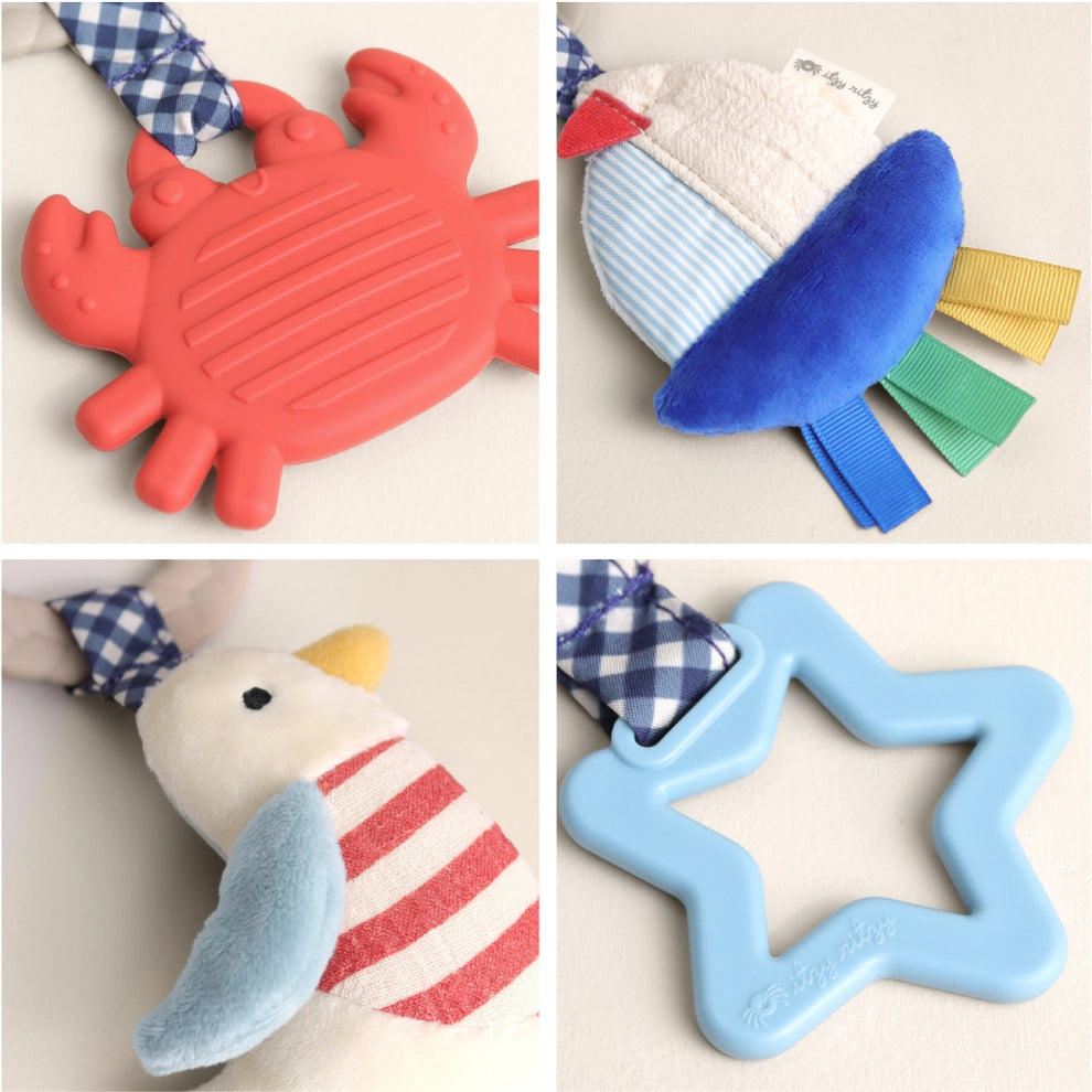 Nautical-themed baby activity toy with plush seagull, crab teether, star teether, and ribbon tags