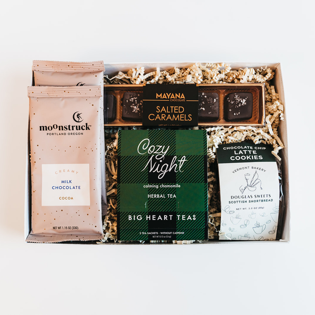 Gift box with moonstruck chocolate, Mayana caramels, and tea packages on a white background