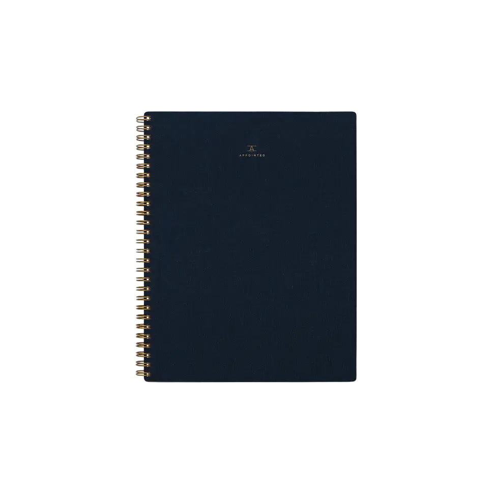 Dark blue spiral-bound notebook on a white background