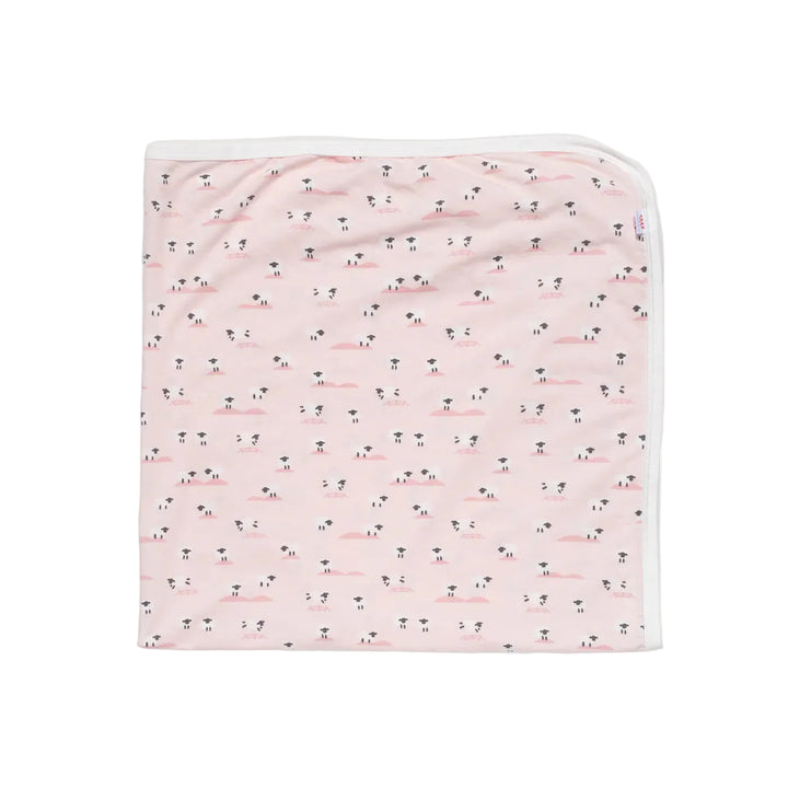 Pink baby blanket with small sheep pattern and white trim, neatly folded