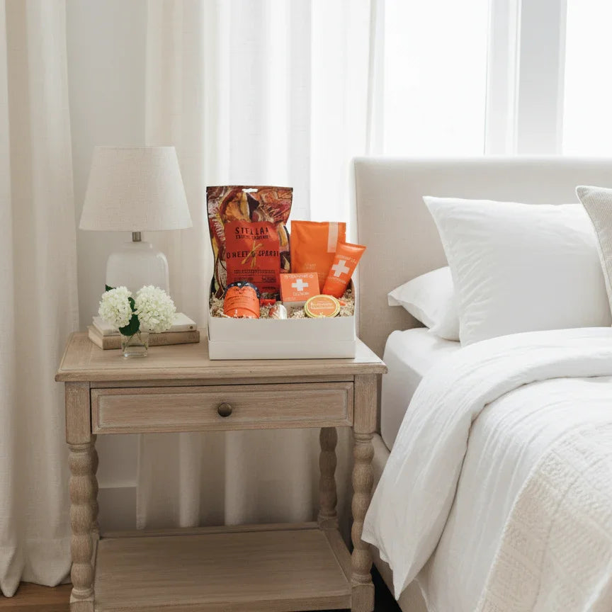 Bedroom with a nightstand and decorative items, including a box of oranges and a lamp.
