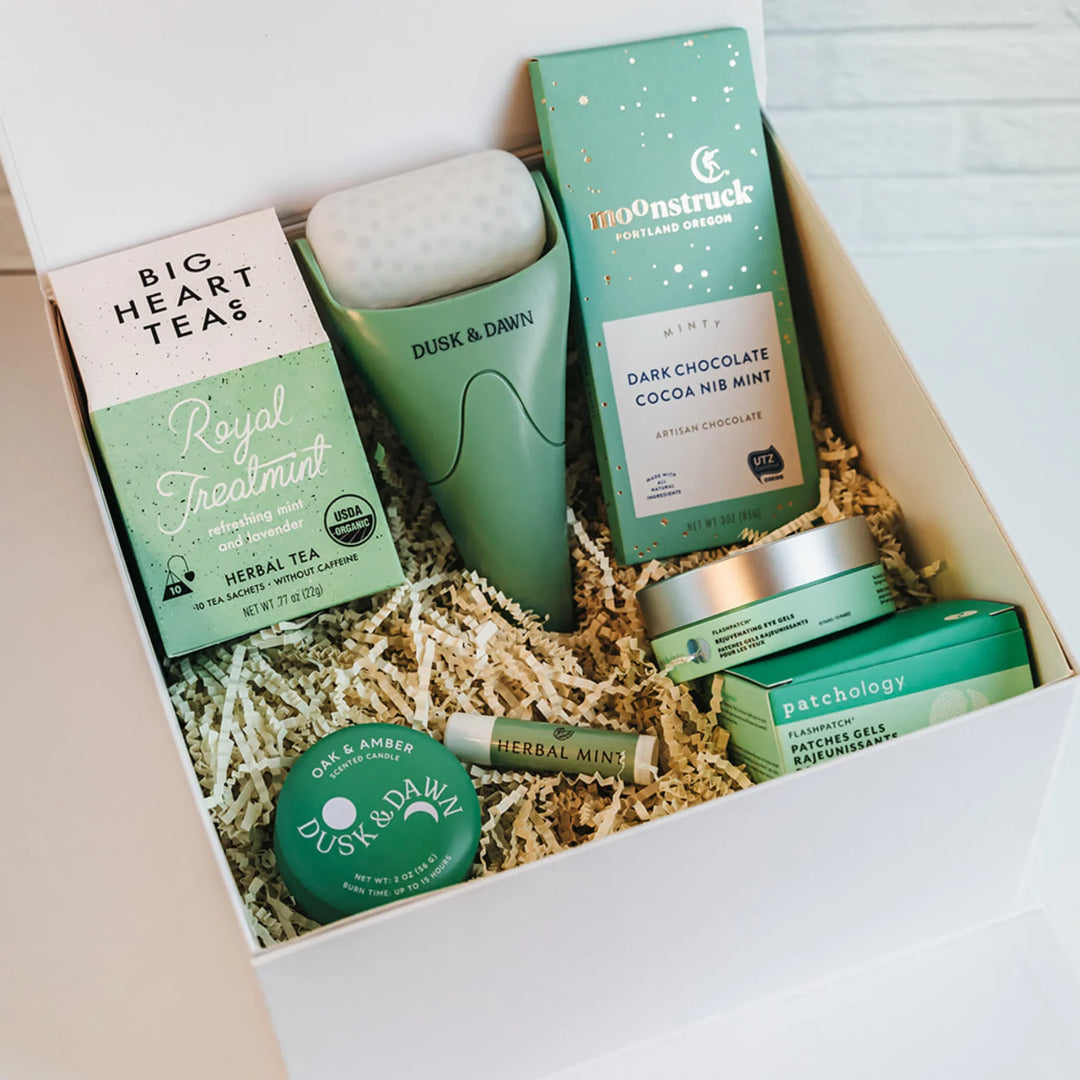 Refresh Ritual Gift Box with tea, candle, lip balm, ice roller, chocolate, and eye gels.