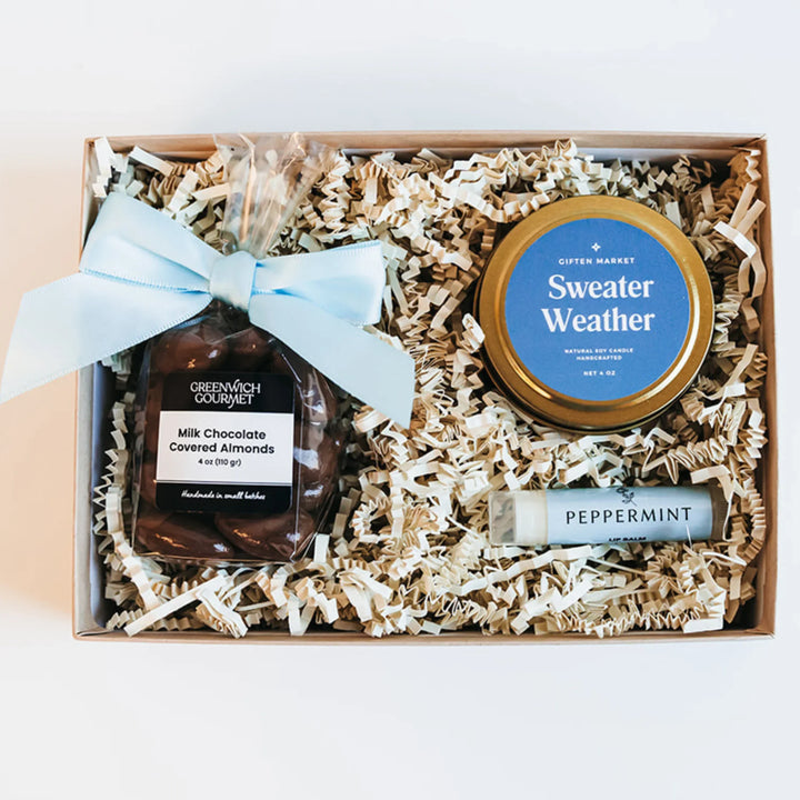 Sweater Weather Mini Bento Box with gold candle, peppermint lip balm, and chocolate-covered almonds.