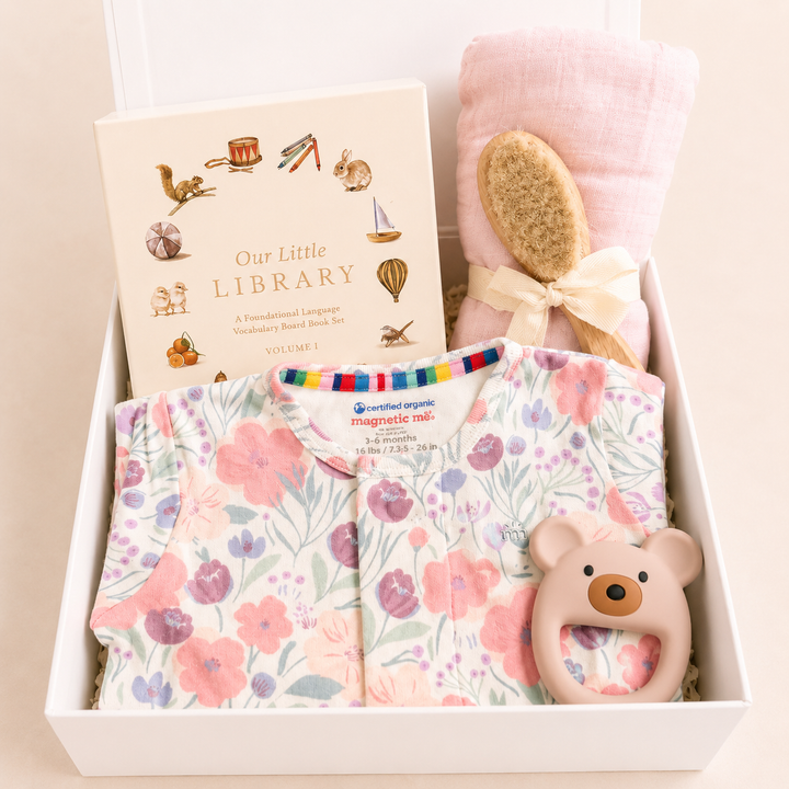 Sweet Beginnings Baby Gift Box in Whistledon floral: floral footie, Our Little Library books, pink swaddle, brush and bear teether