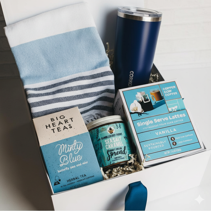Gift set with tea, spread, and a tumbler on a white surface