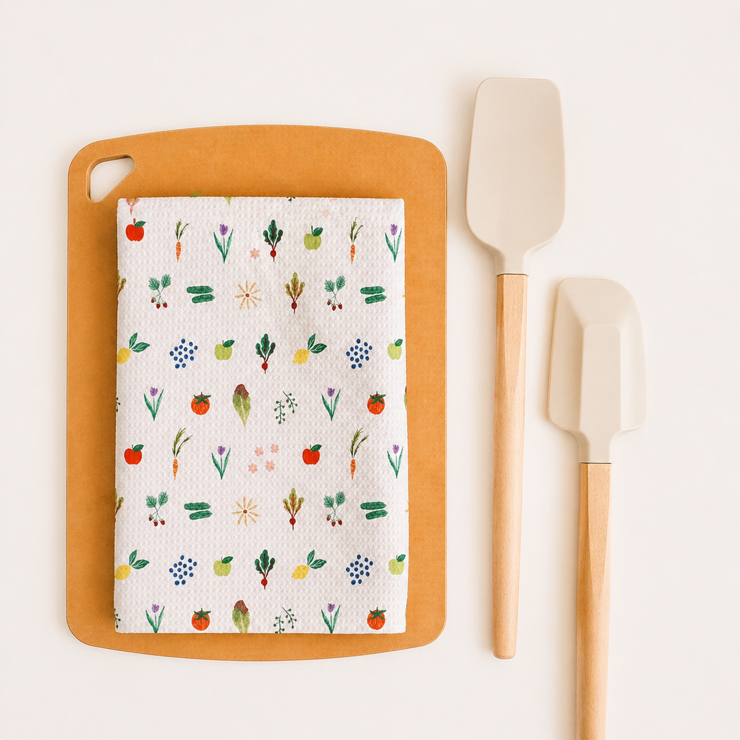 Butterfly kitchen towel on a cutting board with spatulas on a white background