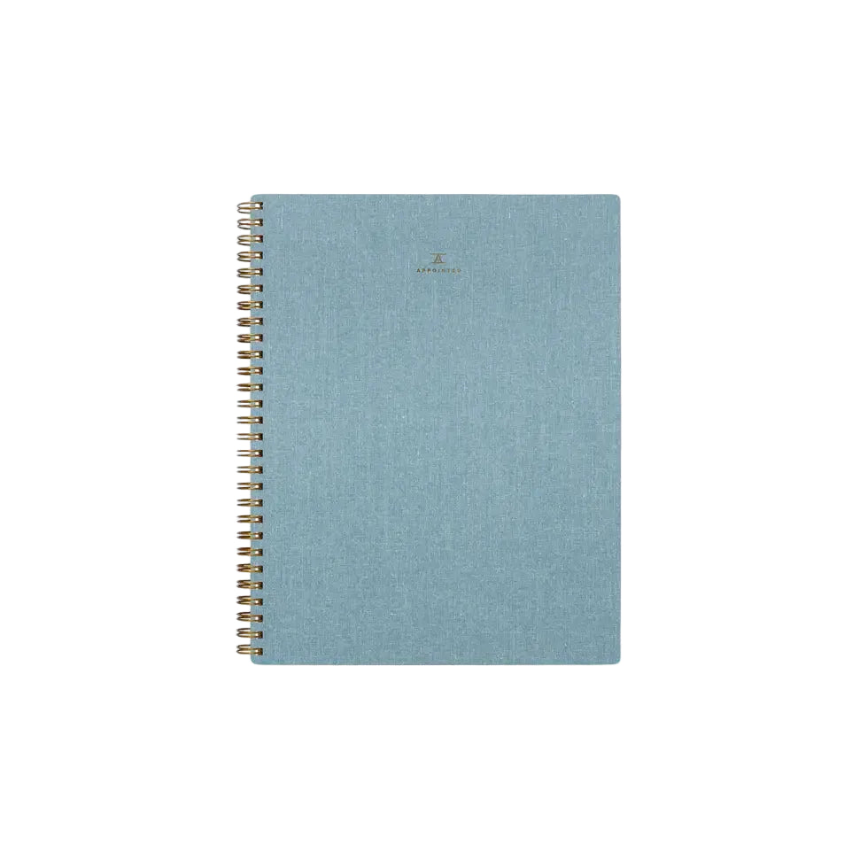 Blue spiral-bound notebook on a white background