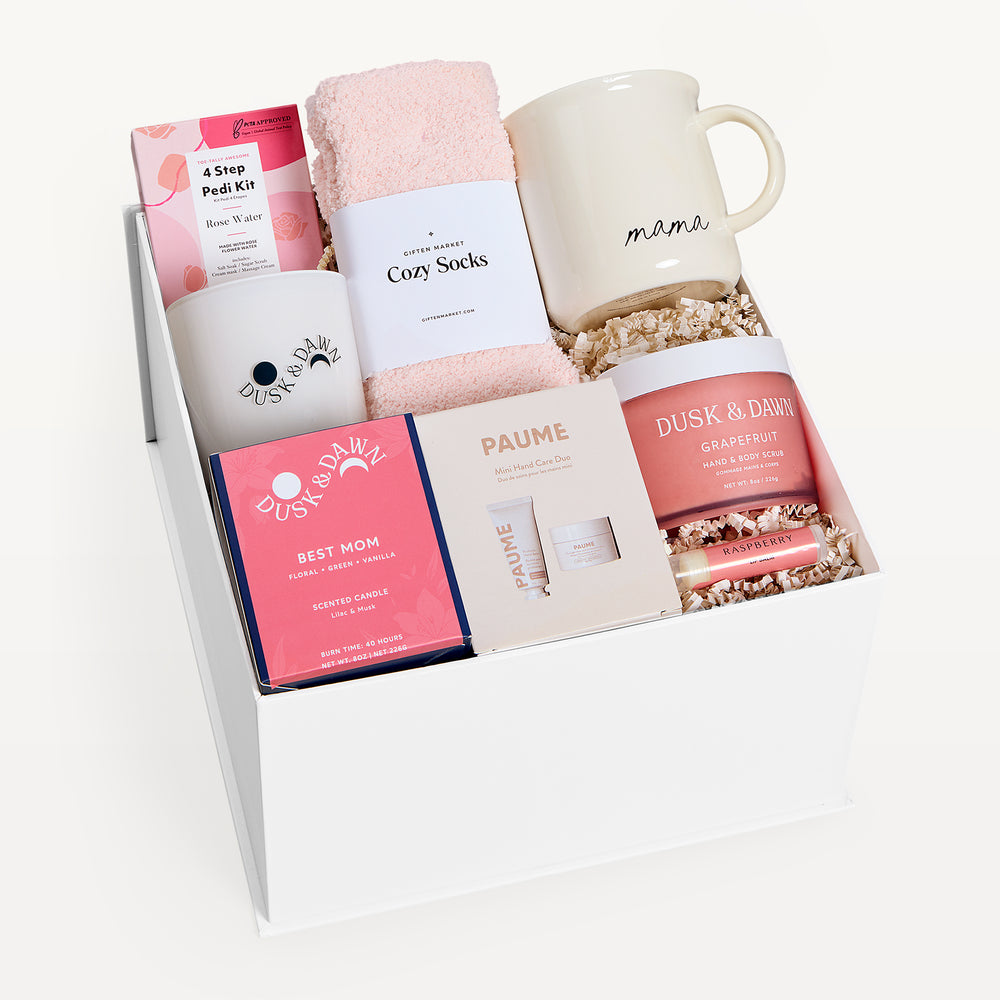 Best Mom Ever Deluxe, white gift box, lid off. Mama mug, pink Cozy Socks, Dusk & Dawn Best Mom candle, 4 Step Pedi Kit, Paume, Grapefruit body butter. Giften Market.