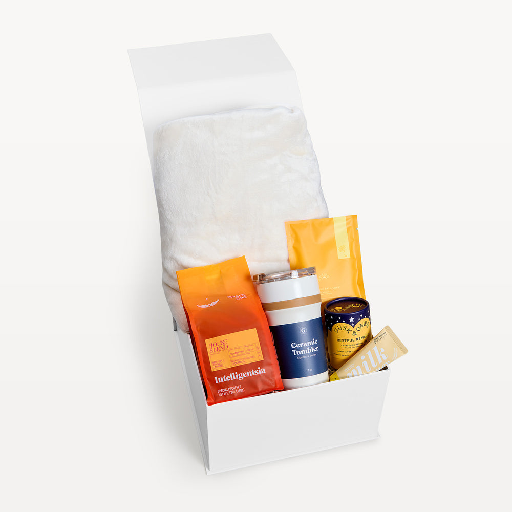 Bright Days Ahead Deluxe, white gift box, lid open, cream faux-fur throw folded behind the coffee, Ceramic Tumbler, tea and Milk bar. Giften Market.
