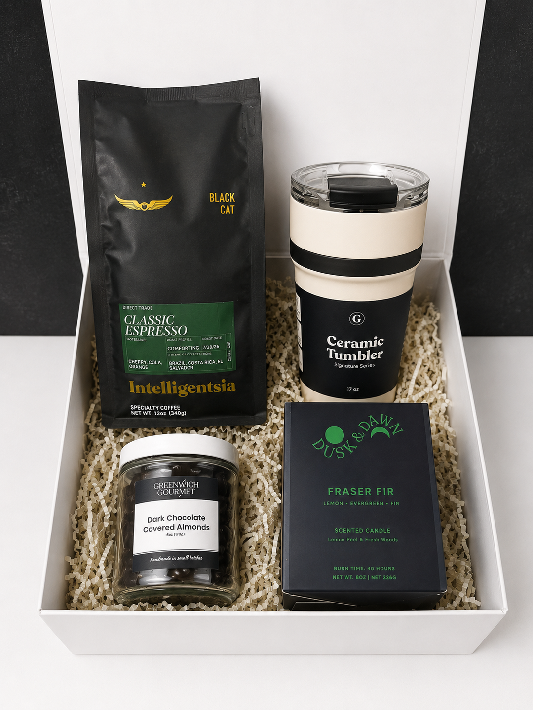 Coffee Break Gift Box, Fraser Fir: Intelligentsia Black Cat espresso, cream ceramic travel tumbler, dark chocolate covered almonds, and a Fraser Fir soy candle in a white gift box