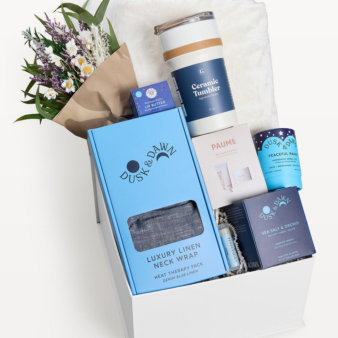 Comfort & Care Gift Box Cream + Blue, close-up of the open white gift box: Luxury Linen Neck Wrap, Ceramic Tumbler, dried bouquet, Peaceful Pause tea, Sea Salt & Orchid candle, Paume. Giften Market.