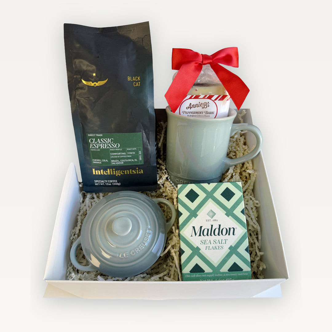 The Holiday Kitchen Espresso Edition gift box in Sea Salt: Le Creuset Vancouver mug and mini cocotte in sage green, Intelligentsia Black Cat espresso, Maldon sea salt flakes, and Annie B&