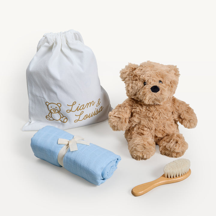 Liam &amp; Louisa Snuggle Set, Archie Bear in blue, loose on the sweep: drawstring bag, tan bear, rolled blue swaddle, wooden brush. Giften Market.