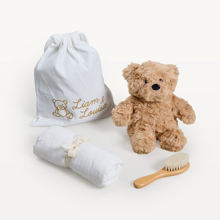 Liam &amp; Louisa Snuggle Set, Archie Bear in ivory, loose on the sweep: drawstring bag, tan bear, rolled ivory swaddle, wooden brush. Giften Market.
