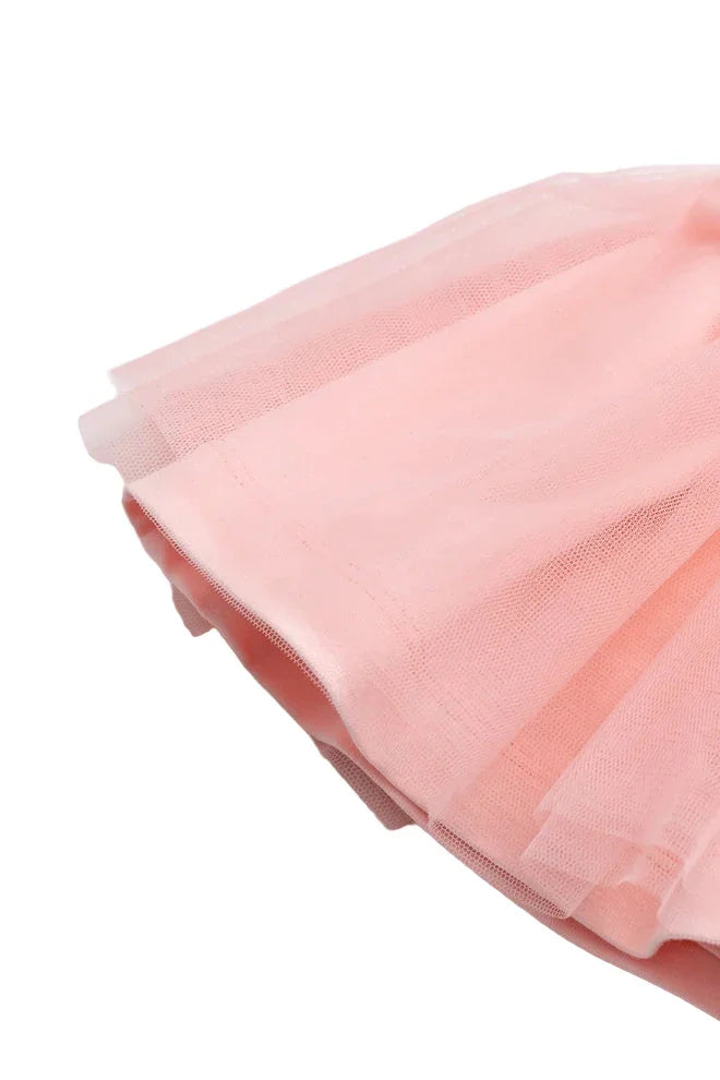 Close-up of soft light pink tulle baby dress skirt with layered fabric detail