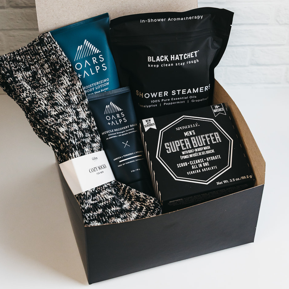 Men’s grooming gift box with cozy socks, shower steamers, lotion, and super buffer