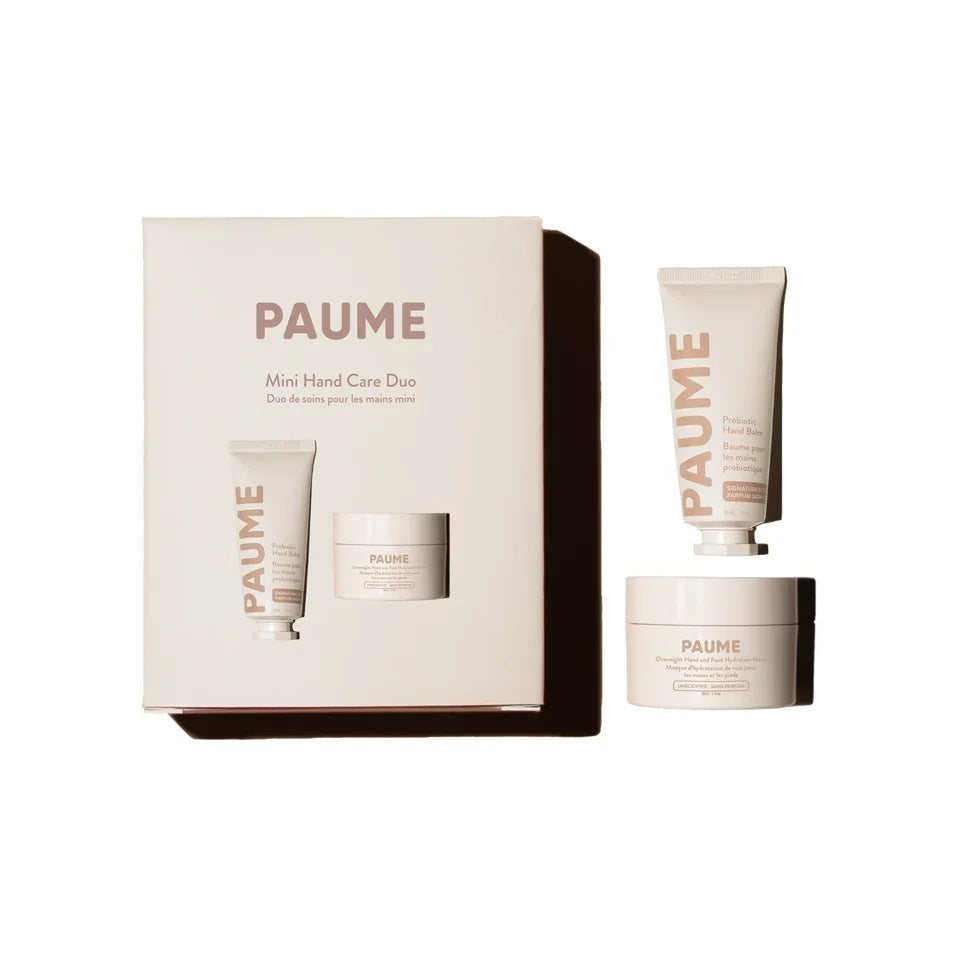 Paume Mini Hand Care Boxed Set with blush box, hand cream tube and hand balm jar on a cream background