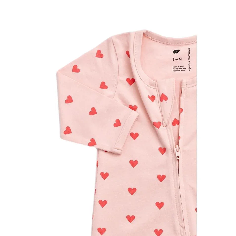 Pink organic cotton baby pajamas with red heart pattern and front zipper