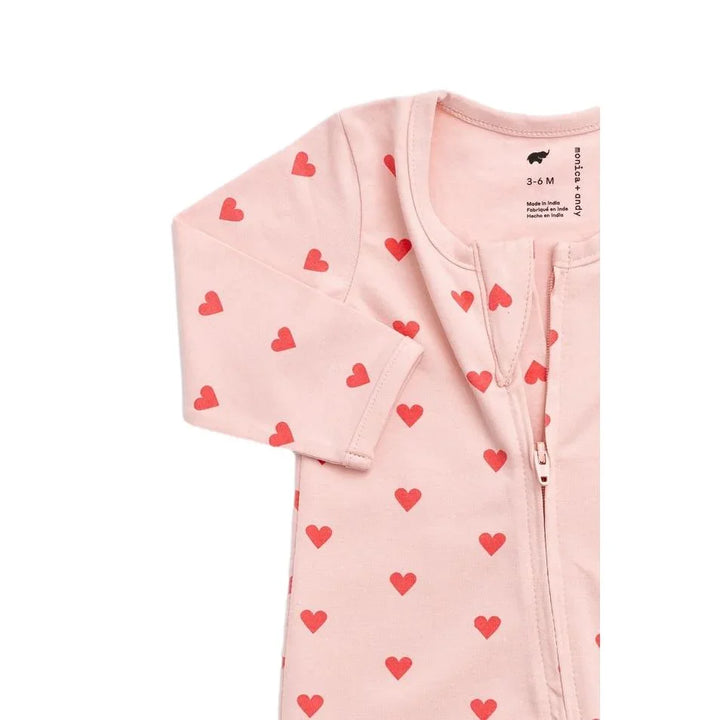 Pink organic cotton baby pajamas with red heart pattern and front zipper