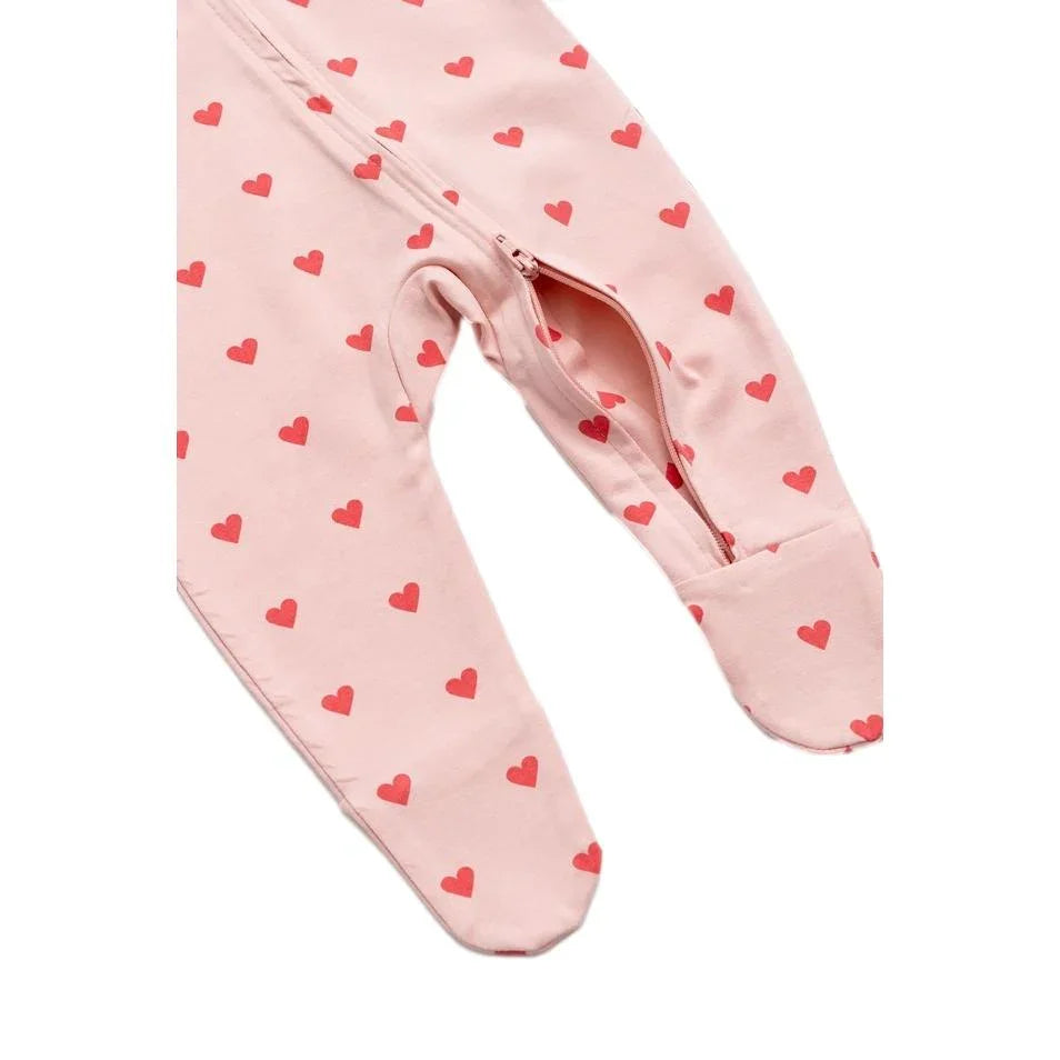Organic cotton baby pajamas with pink and red heart print and a front zipper closure
