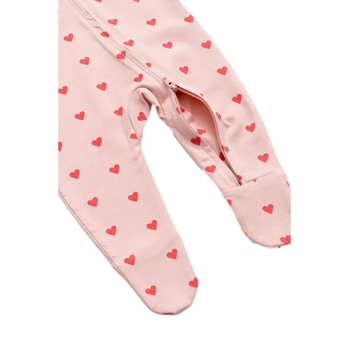 Organic cotton baby pajamas with pink and red heart print and a front zipper closure