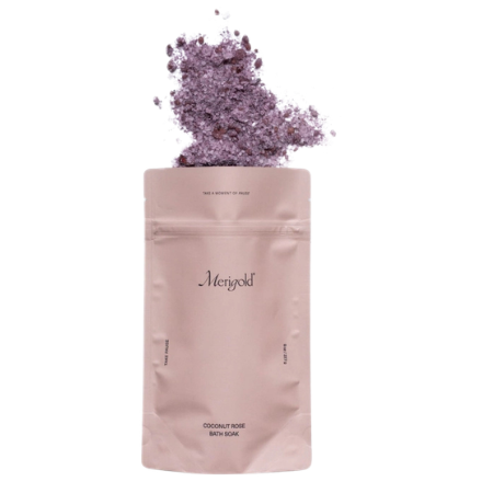 Coconut rose bath soak in a blush pink pouch, lavender floral salts spilling out