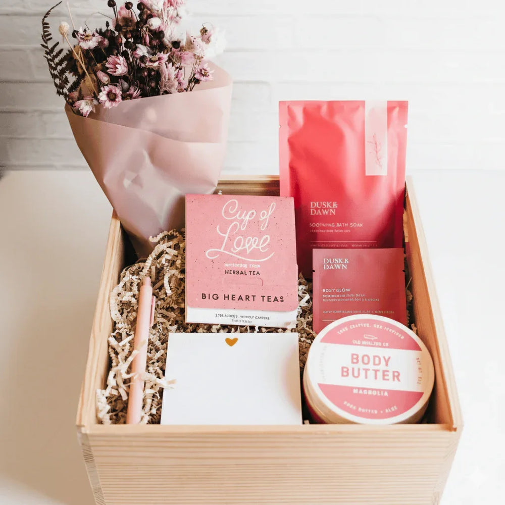 Wooden gift crate with dried flowers, herbal tea, bath soak, body butter, and notecard