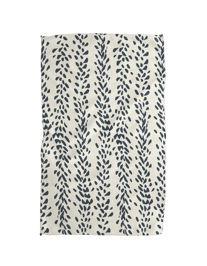 Cotton tea towel with navy botanical print on a cream background, laid flat