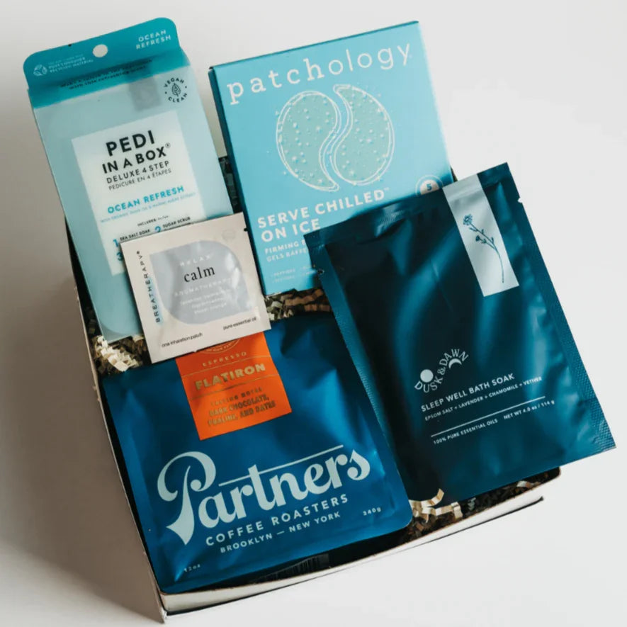 Relaxation Reset Gift Box open with Partners Coffee Roasters bag, Pedi in a Box, eye gels and Dusk & Dawn bath soak