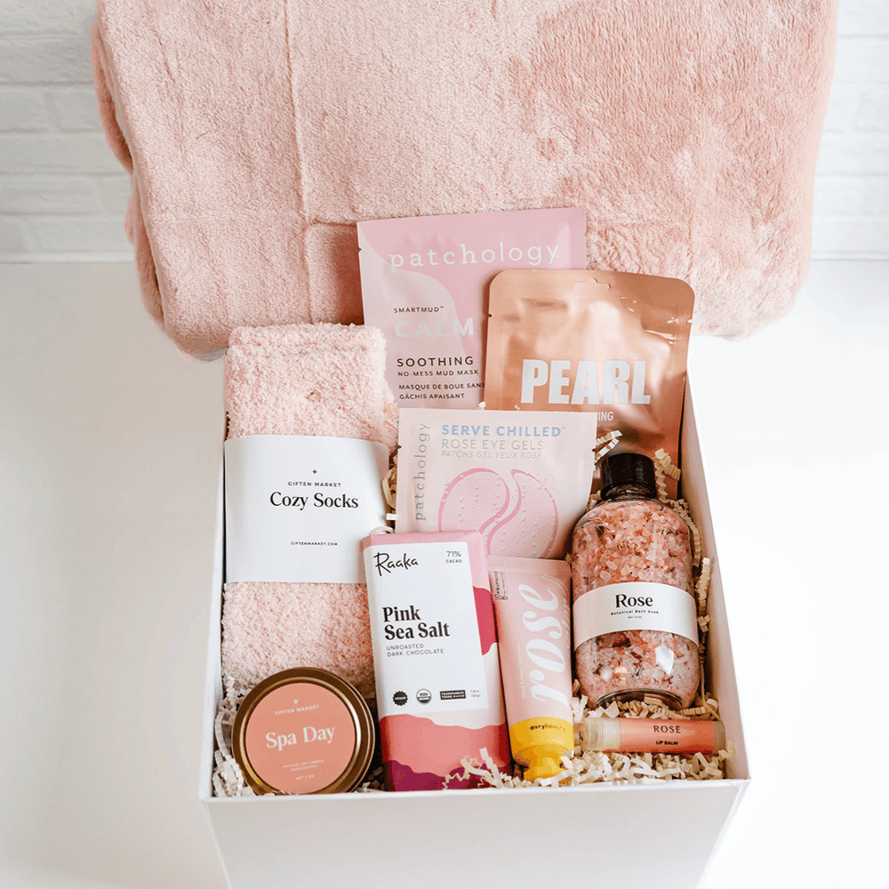 Rosy Outlook Beauty Gift Box Deluxe with pink cozy socks, Patchology masks, Raaka pink sea salt chocolate, rose bath salts and Spa Day candle