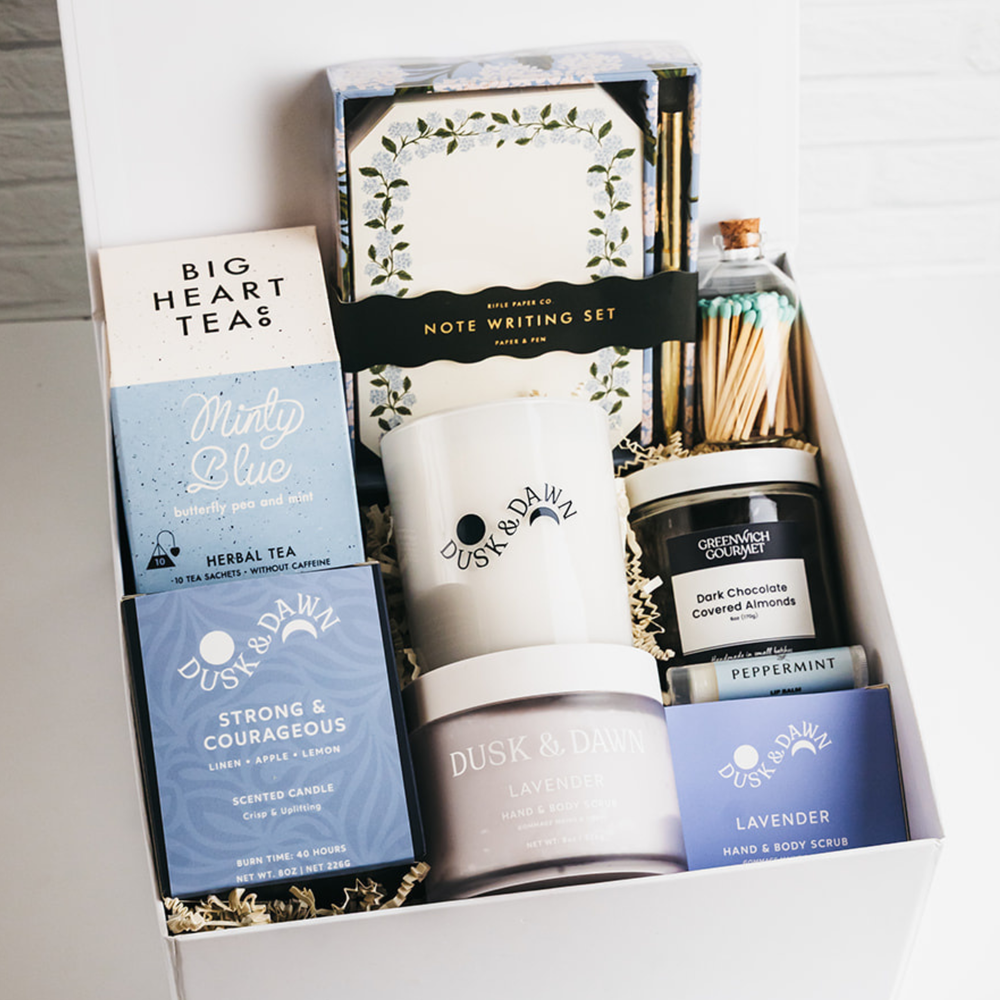 Premium gift box with herbal tea, candle, lavender scrub, chocolate almonds, and notecard set