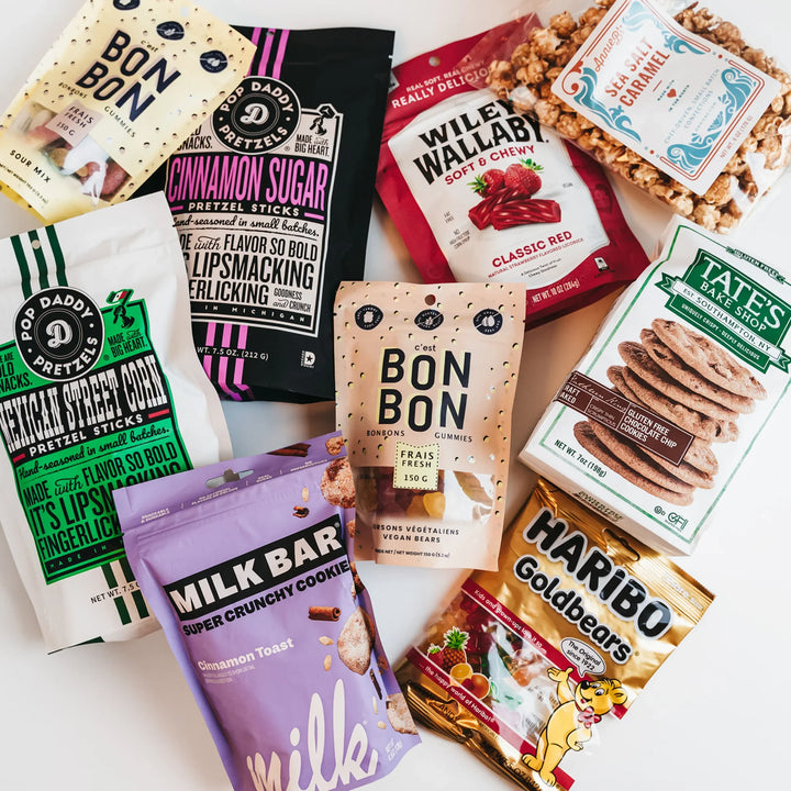 Assorted snack packages including Tate's, Haribo, and Milk Bar on a white background