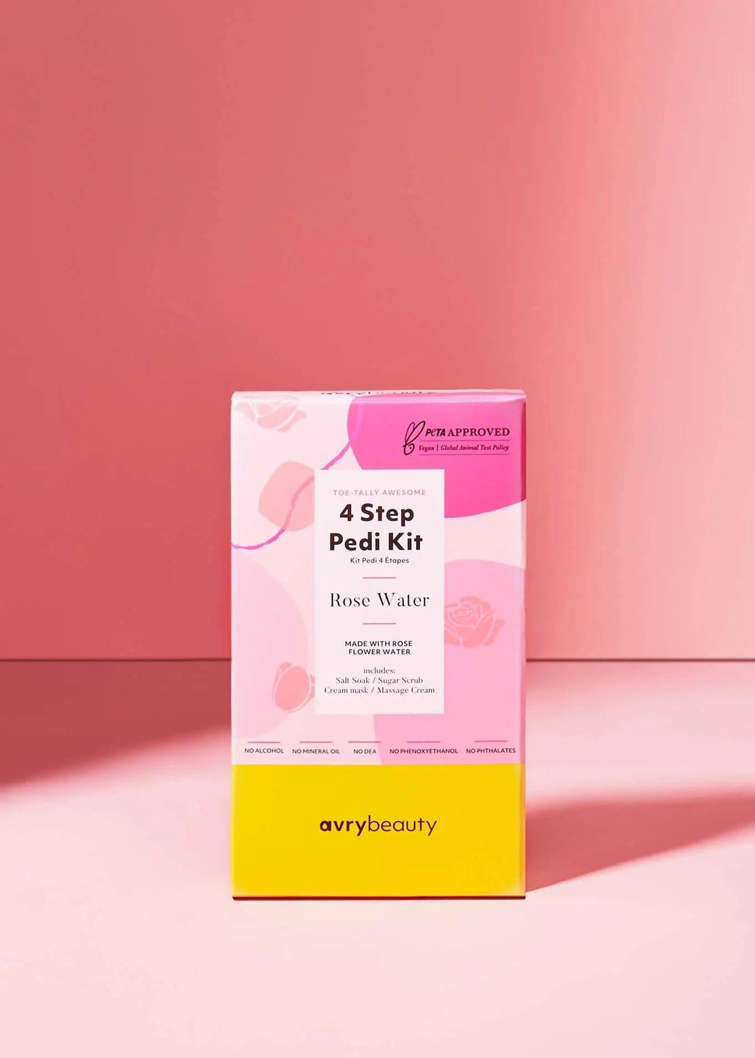 Rose Water 4-step pedi kit box with pink and yellow packaging on a pink background